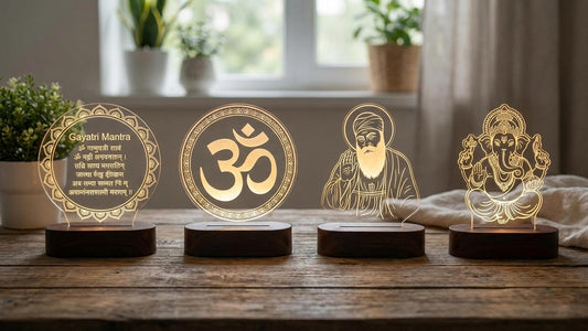 Four glowing acrylic night led lamps on wooden bases displaying Hindu and Sikh religious designs