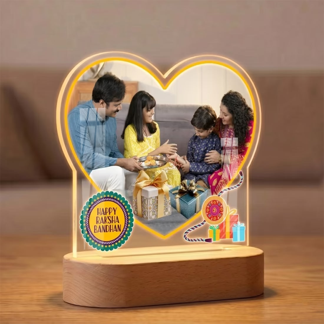 Heart-shaped lamp with a family photo and 'Happy Raksha Bandhan' text on a frame with Led wooden base.