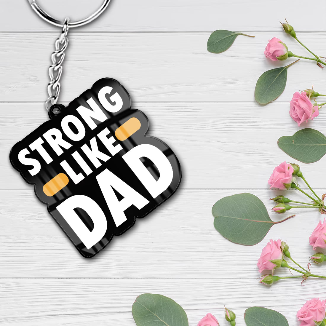 Strong Like Dad acrylic keychain with bold white typography and metal ring