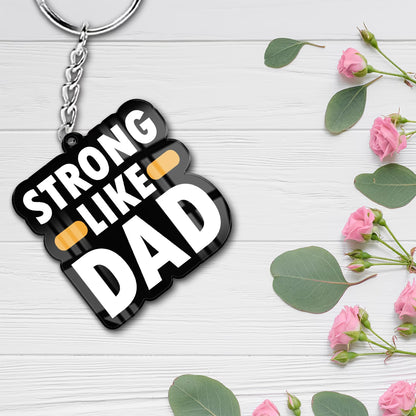 Strong Like Dad acrylic keychain with bold white typography and metal ring