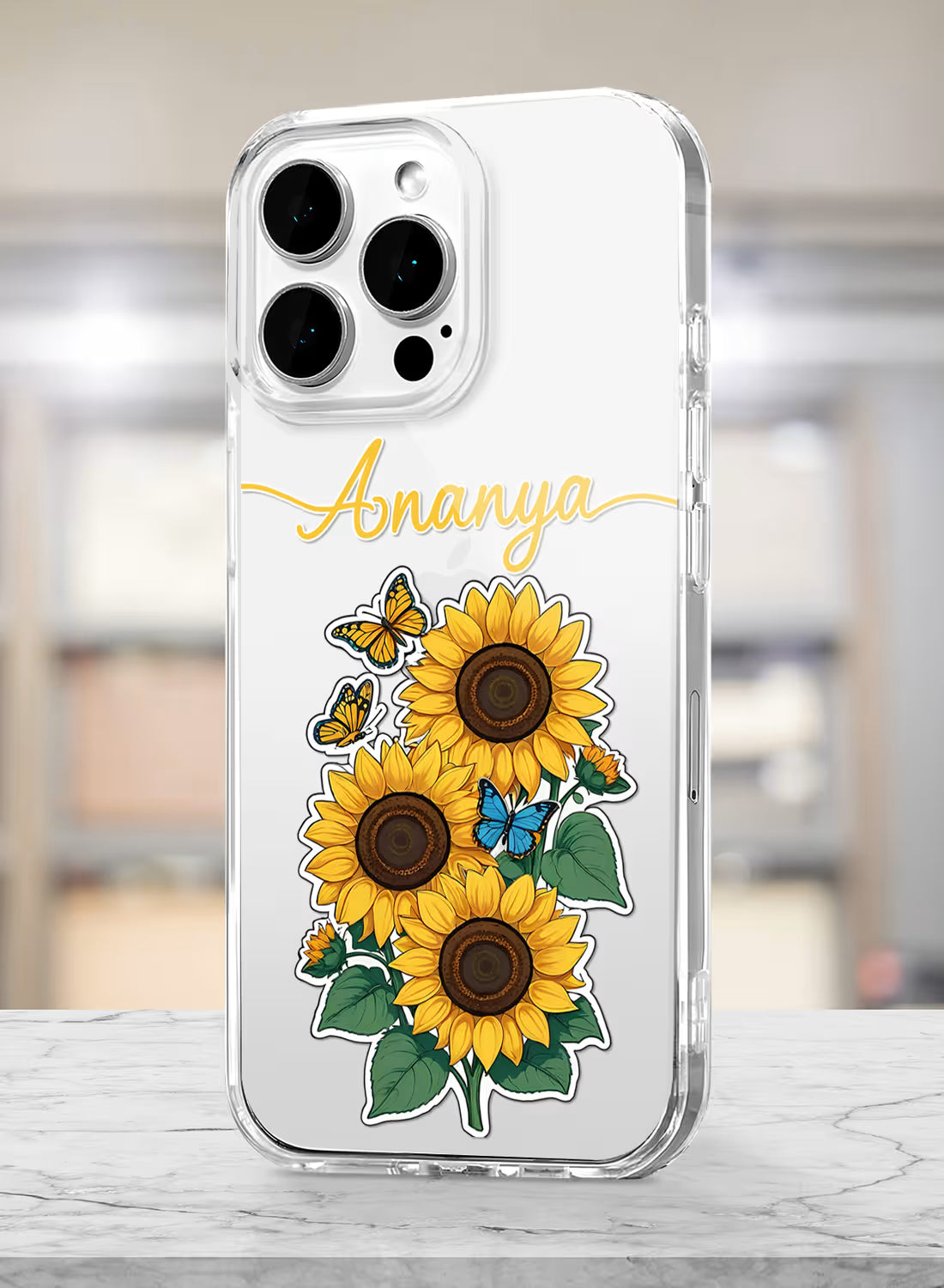 Custom name Ananya printed in golden script on clear silicone phone cover with sunflower and butterfly design
