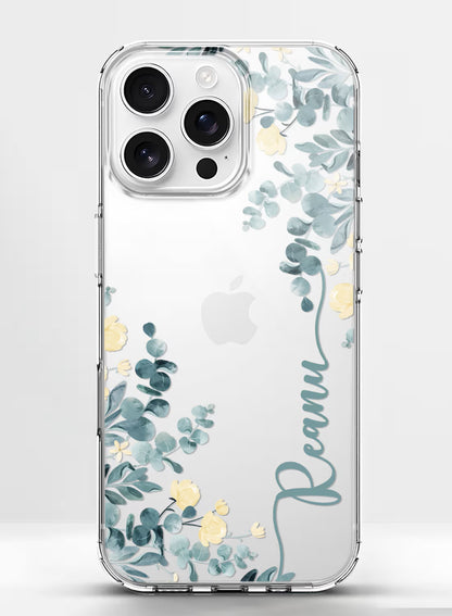 Custom name Reanu printed vertically in teal script on a clear silicone phone case featuring a watercolor eucalyptus and yellow floral design.