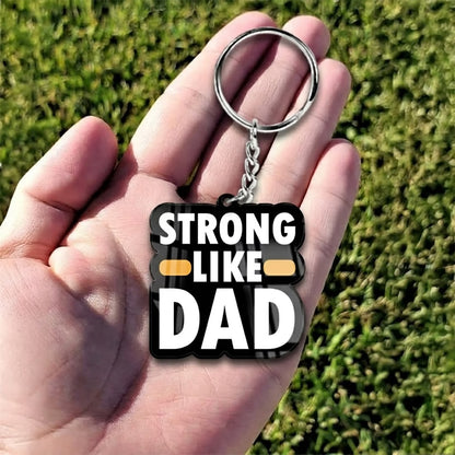 Strong Like Dad acrylic keychain with bold white typography and metal ring
