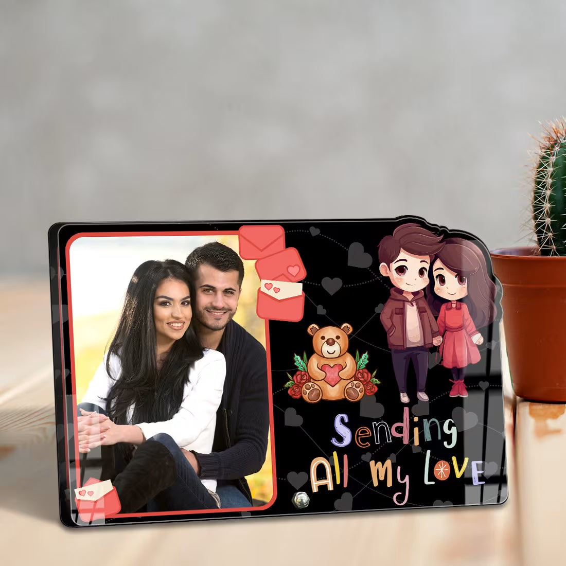 Custom couple photo frame. Black acrylic stand with 'Sending All My Love' text, cartoon couple, and teddy bear.
