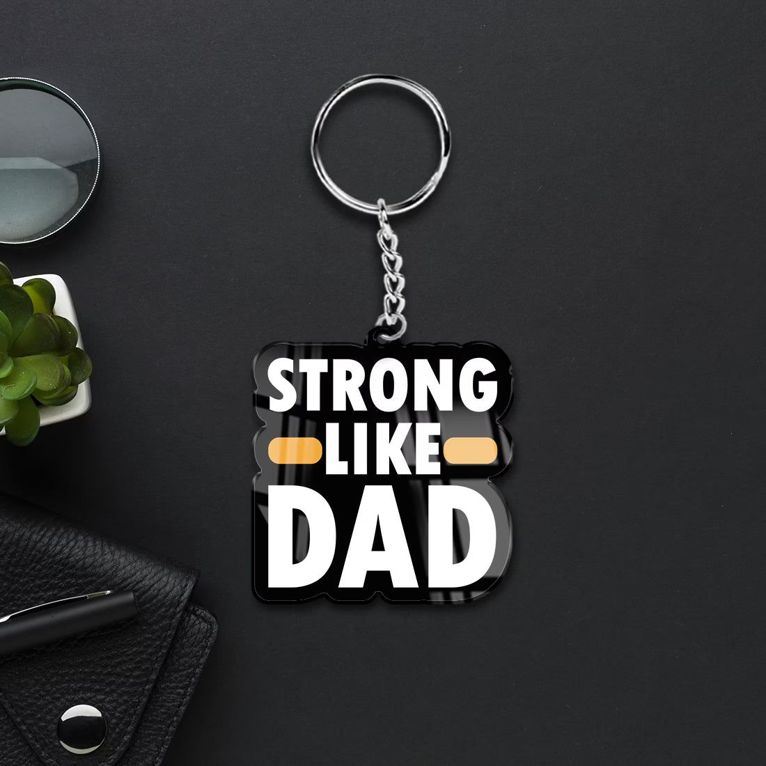 Strong Like Dad acrylic keychain with bold white typography and metal ring