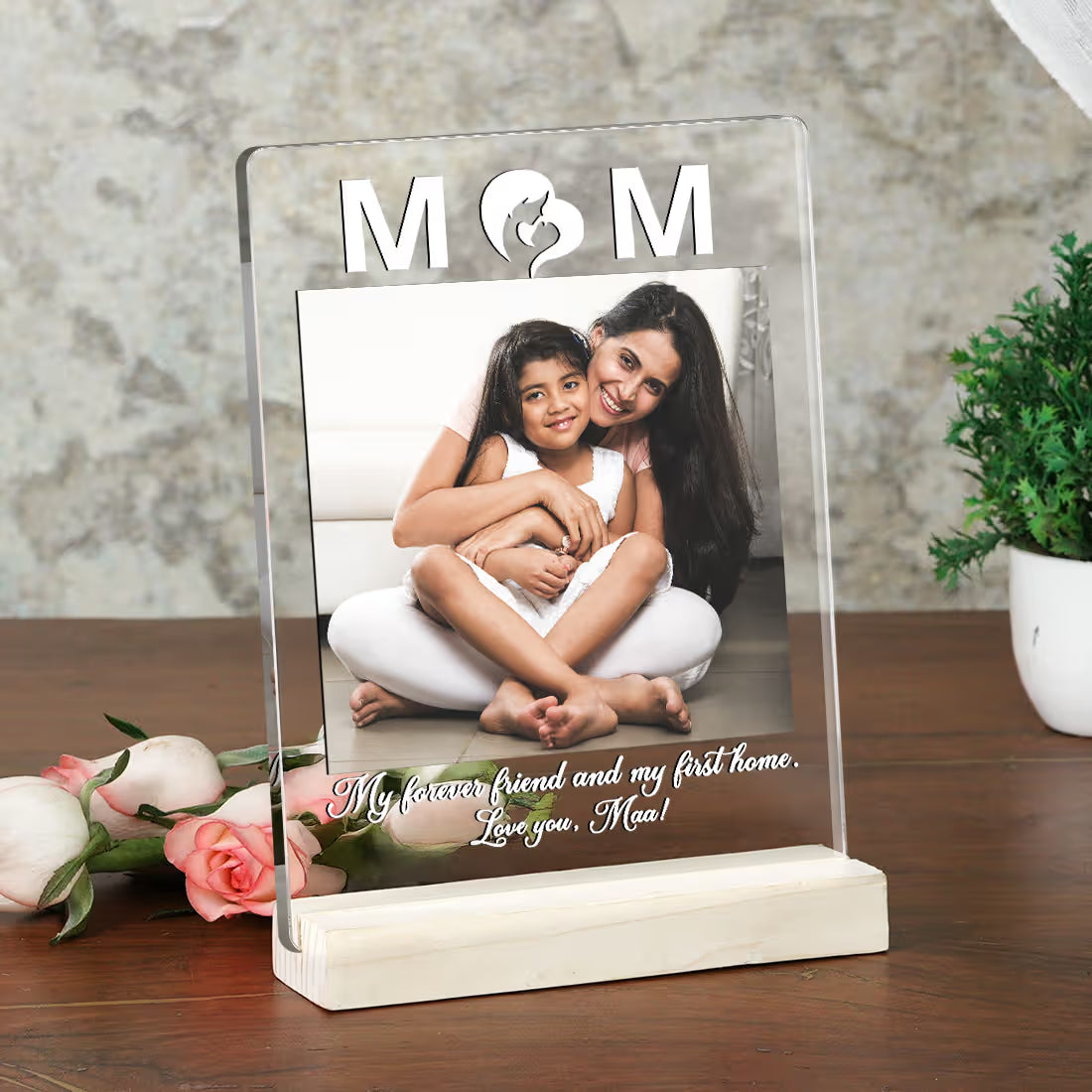 Personalised photo frame with a mother and daughter photo on a wooden surface.