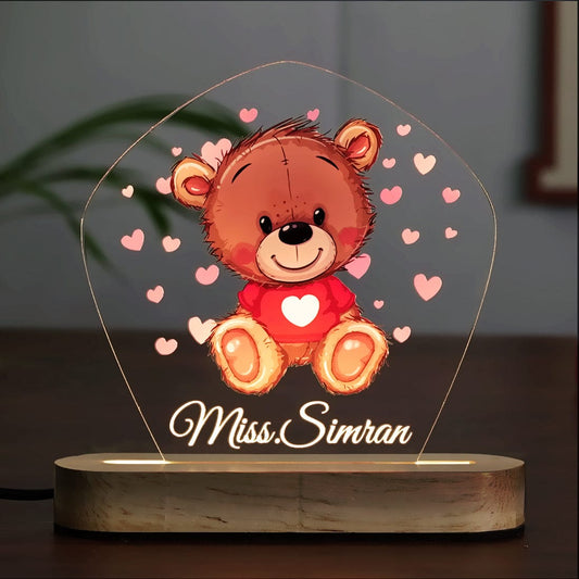 Adorable Teddy Theme Acrylic LED Night Lamp placed on a bedside table for warm night glow at Fashionury