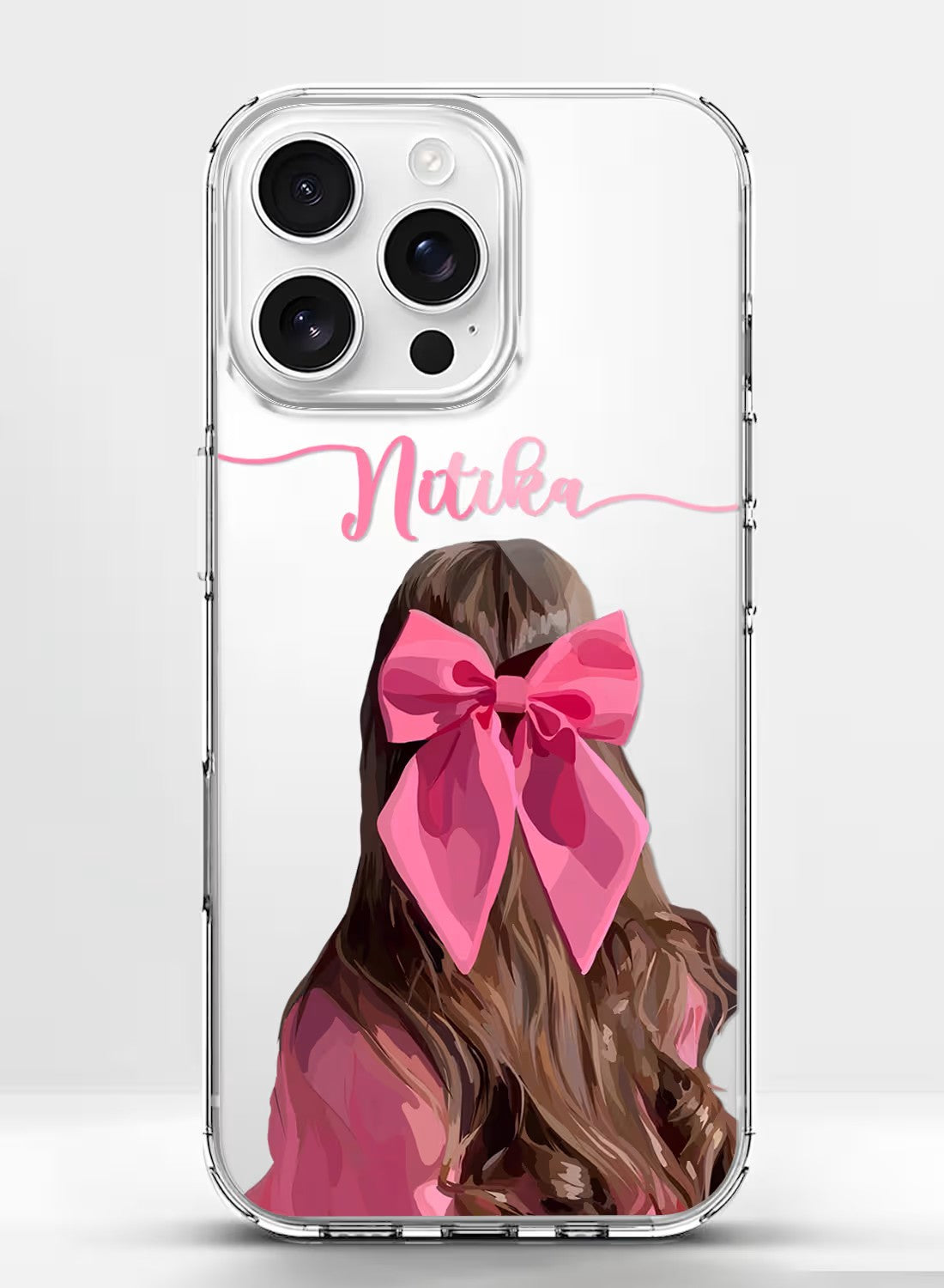 A clear phone case featuring an artistic design of a girl with a large pink bow, with space for a custom name.