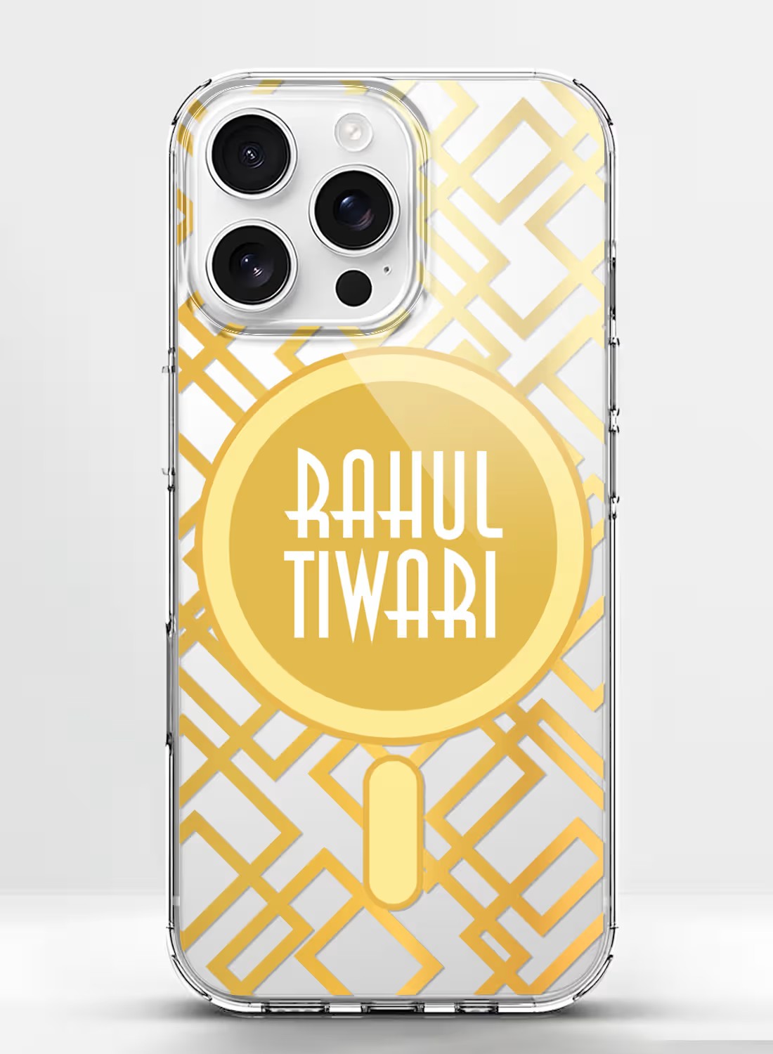 A clear smartphone case with a gold geometric pattern and a central circle for a custom name, displayed in a stylish hand.