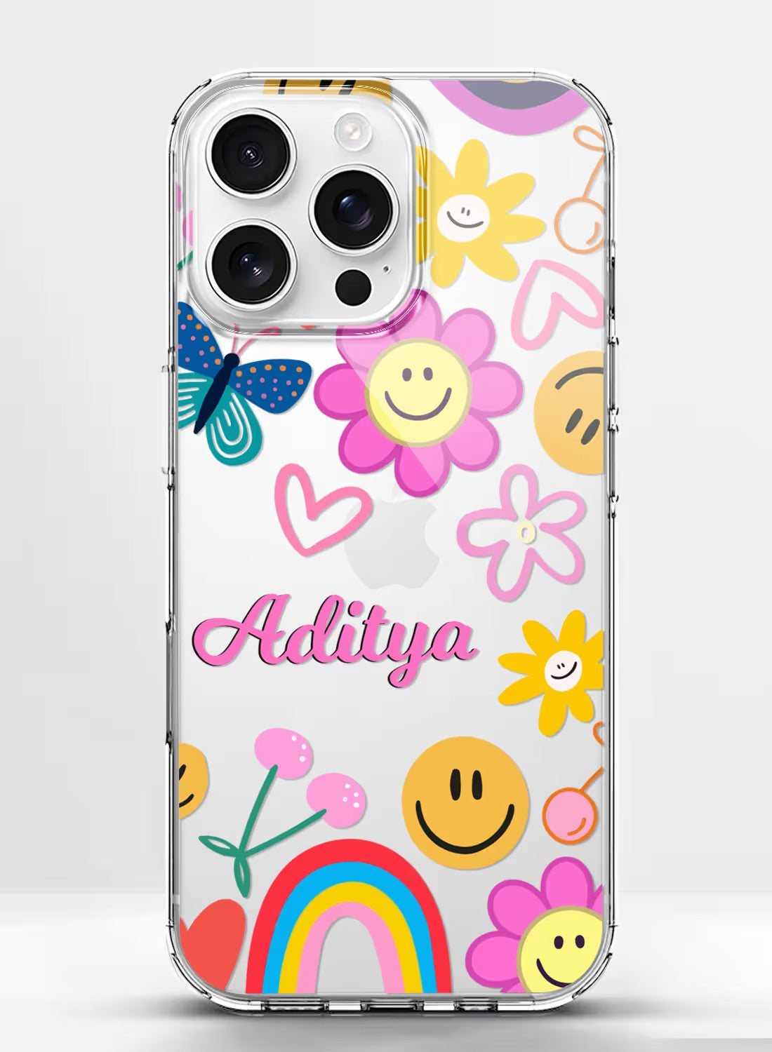 A clear phone case featuring a colorful pattern of smiley faces, flowers, and rainbows with a customizable name section.