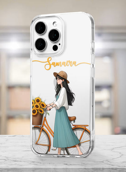 A clear phone case featuring a stylish girl wearing a fedora hat with a sunflower-filled bicycle and custom name text.