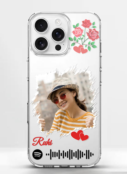 A personalized clear silicone phone case featuring a photo, rose art, hearts, and a customizable music scan code.