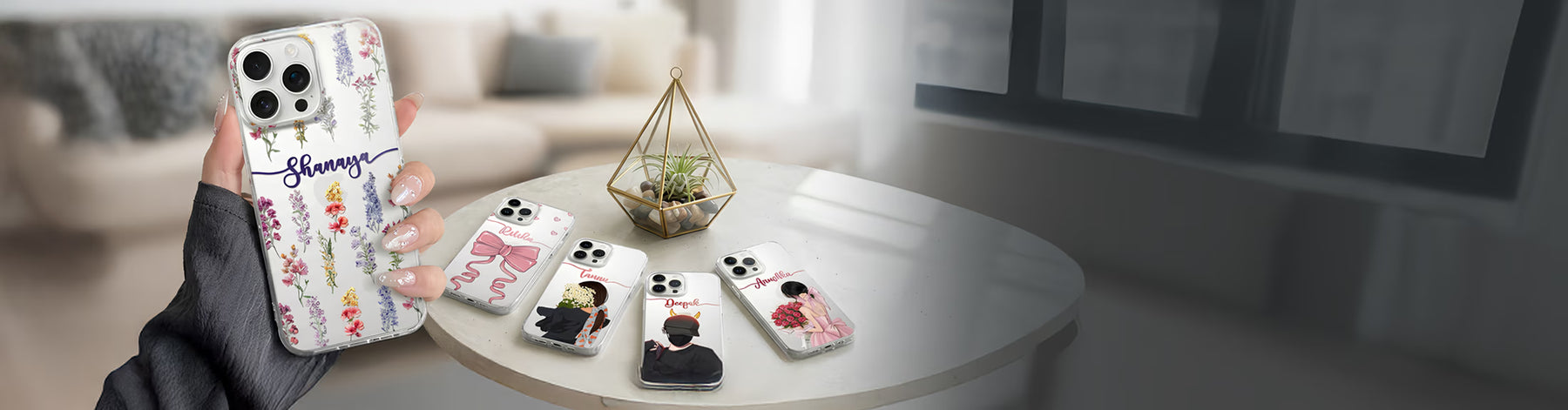Person holding a phone case with floral design, surrounded by other phone cases on a table.