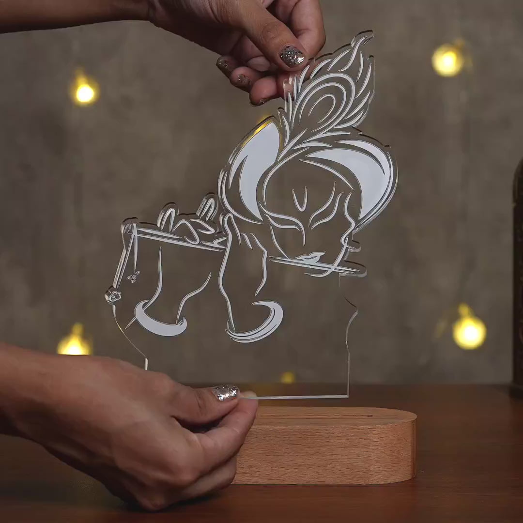 Showcase video of Krishna flute 3D engraved acrylic LED lamp with warm glow and rechargeable wireless wooden base – Fashionury