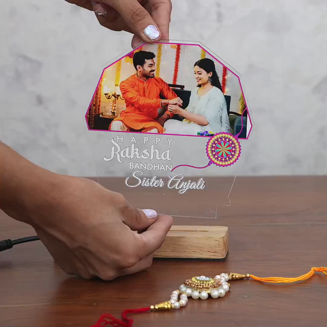 Showcase video of Personalized Raksha Bandhan acrylic LED lamp with custom photo and name, rakhi design and wooden base – Fashionury