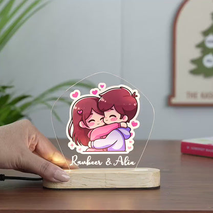 Panning video showing the cute facial expressions of the cartoon couple and the glowing custom led names