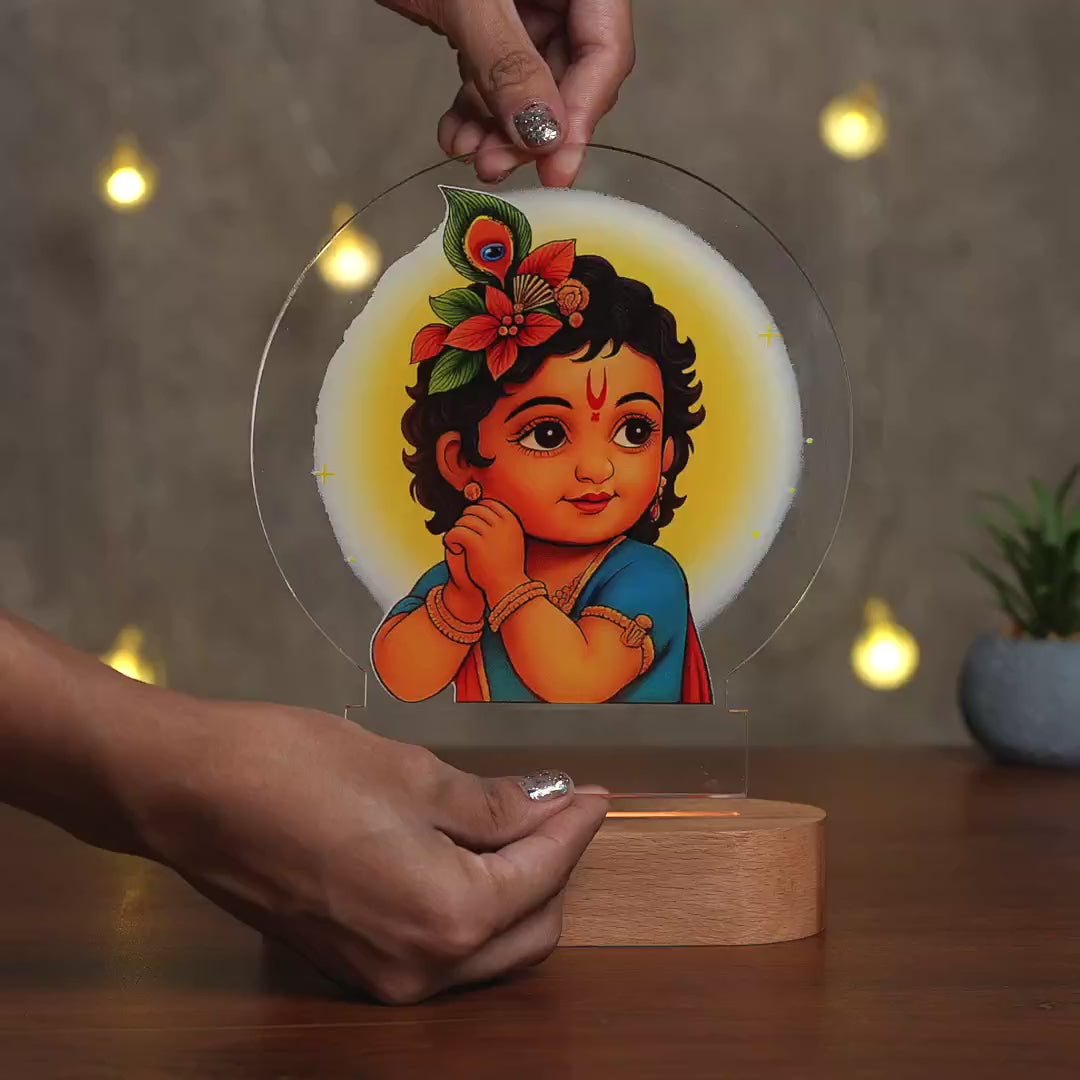 Showcase Video of Bal Gopal Little Krishna acrylic LED night lamp with rechargeable wireless wooden base – Janmashtami gift by Fashionury