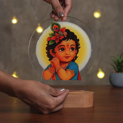Showcase Video of Bal Gopal Little Krishna acrylic LED night lamp with rechargeable wireless wooden base – Janmashtami gift by Fashionury